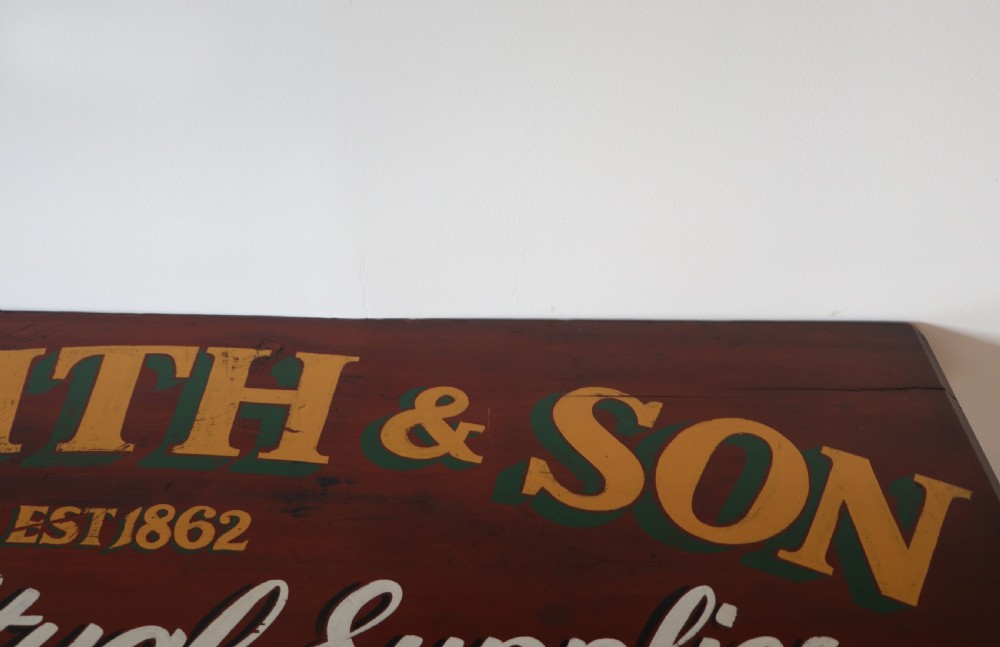 A Victorian red painted pine chest of four drawers featuring white, yellow, and green hand-painted commercial sign-writing and cut glass knobs. View X