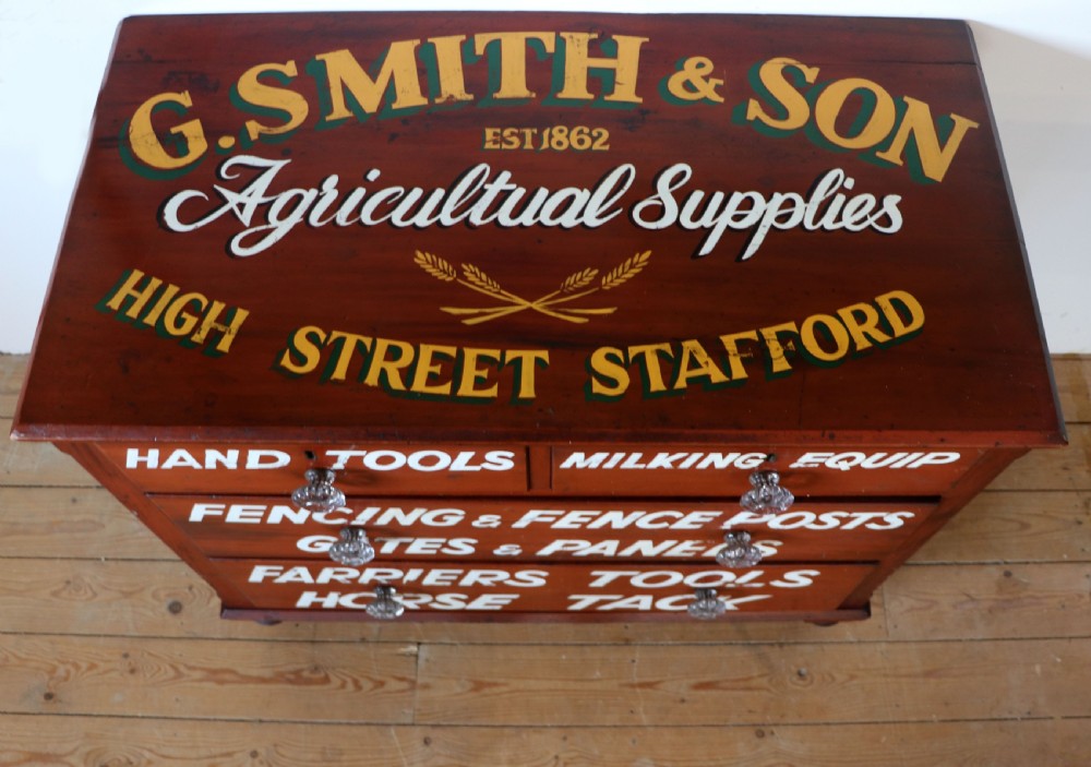 A Victorian red painted pine chest of four drawers featuring white, yellow, and green hand-painted commercial sign-writing and cut glass knobs. View XI