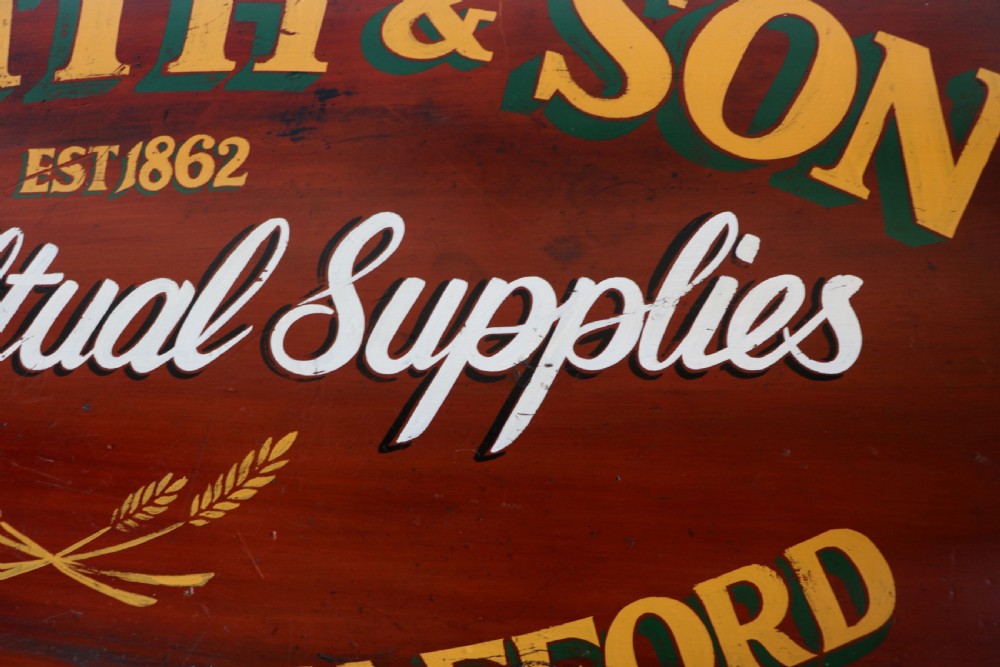 A Victorian red painted pine chest of four drawers featuring white, yellow, and green hand-painted commercial sign-writing and cut glass knobs. View XIV