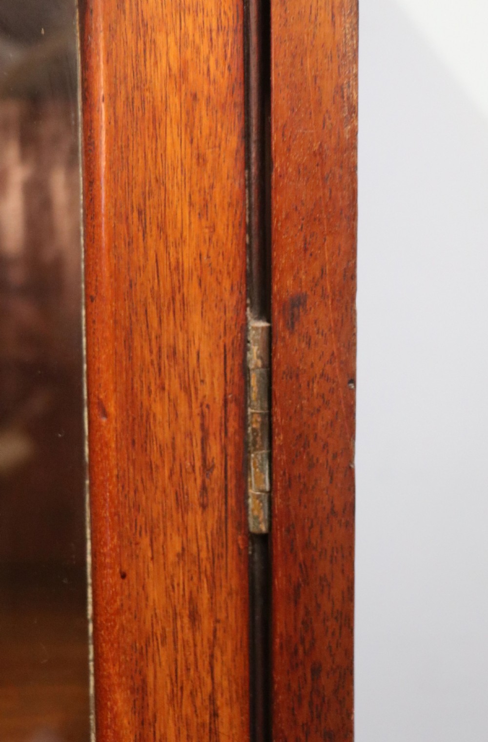 An early twentieth-century mahogany framed bookcase featuring two glazed doors decorated with the Home Office royal coat of arms stencil, supported on cabriole legs. View XVI