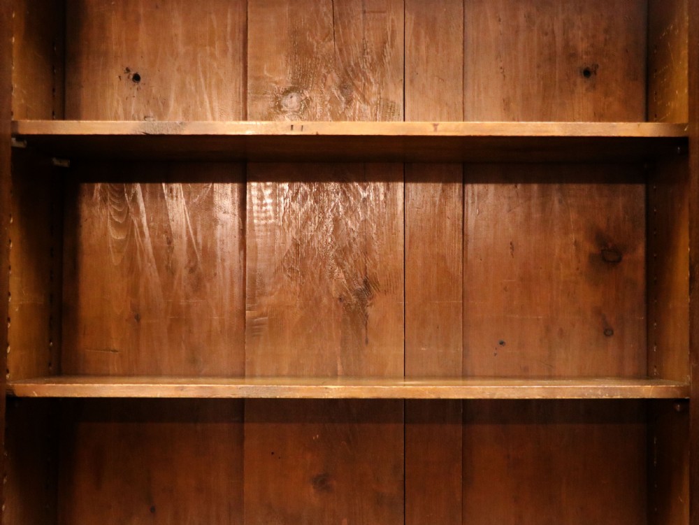 An early twentieth-century mahogany framed bookcase featuring two glazed doors decorated with the Home Office royal coat of arms stencil, supported on cabriole legs. View XXI