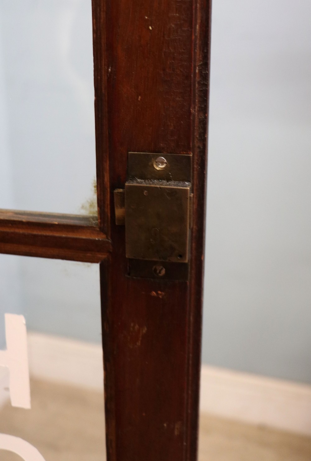 An early twentieth-century mahogany framed bookcase featuring two glazed doors decorated with the Home Office royal coat of arms stencil, supported on cabriole legs. View XXIII