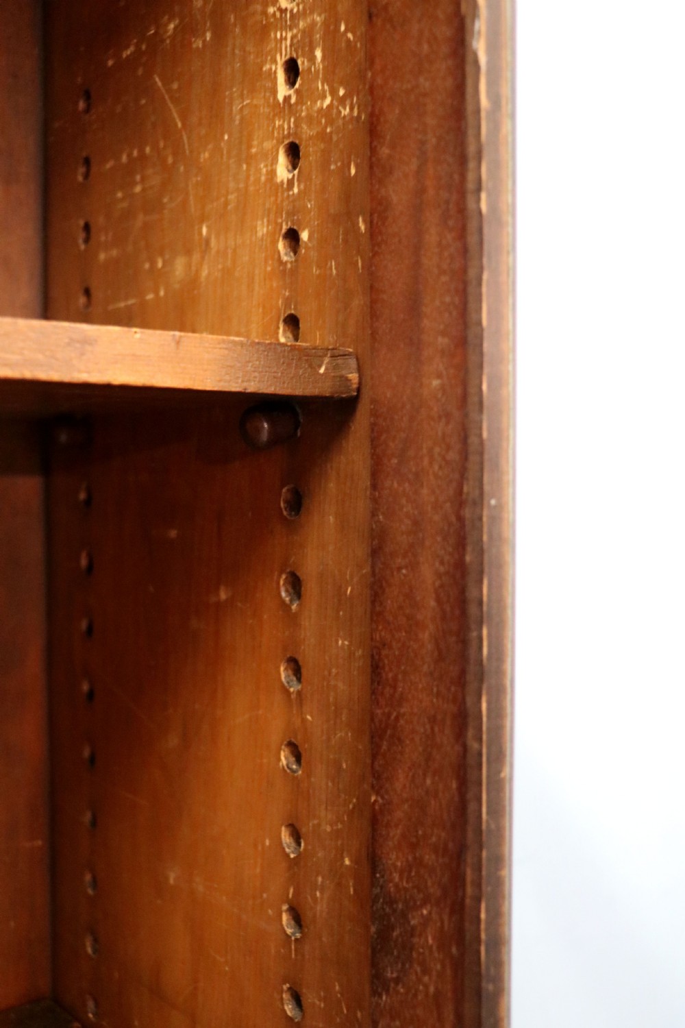 An early twentieth-century mahogany framed bookcase featuring two glazed doors decorated with the Home Office royal coat of arms stencil, supported on cabriole legs. View XXIV