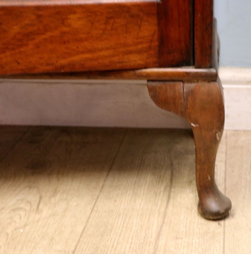 An early twentieth-century mahogany framed bookcase featuring two glazed doors decorated with the Home Office royal coat of arms stencil, supported on cabriole legs. View XXVIII