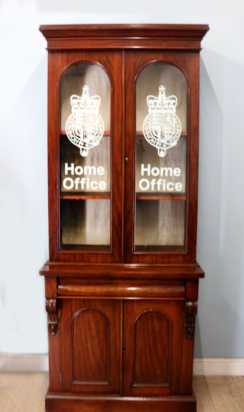 A beautiful quality Victorian mahogany bookcase cabinet, later sign written with the Home Office logo. 
