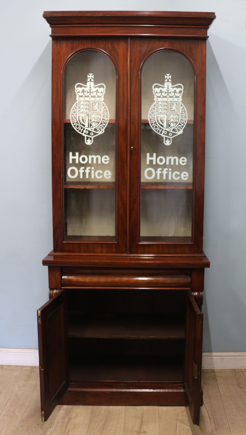 A beautiful quality Victorian mahogany bookcase cabinet, later sign written with the Home Office logo.  View IV