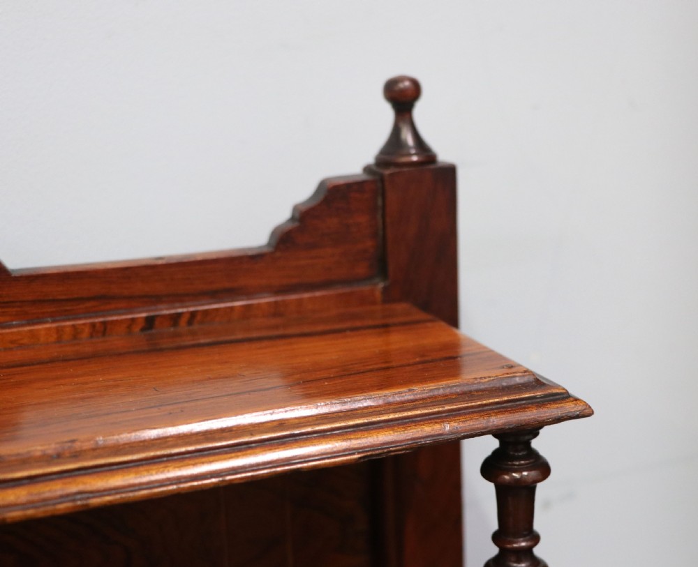 A late nineteenth-century dark hardwood music cabinet featuring floral marquetry inlay on the upper door, an oval mirror panel framed by scroll carving below, and a galleried upper shelf. View XII