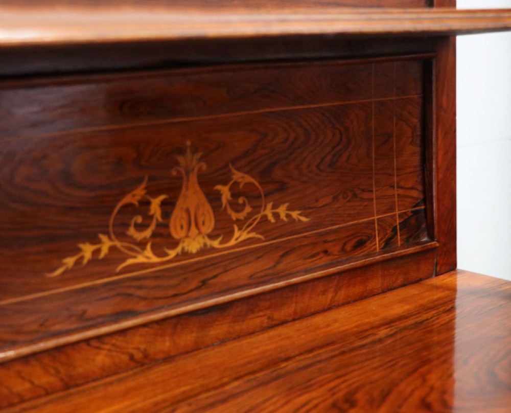 A late nineteenth-century dark hardwood music cabinet featuring floral marquetry inlay on the upper door, an oval mirror panel framed by scroll carving below, and a galleried upper shelf. View XIX