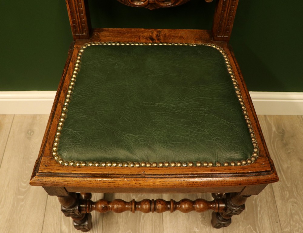 A lovely Victorian oak framed beautifully carved hall chair in the Carolean gothic revival style. View XII