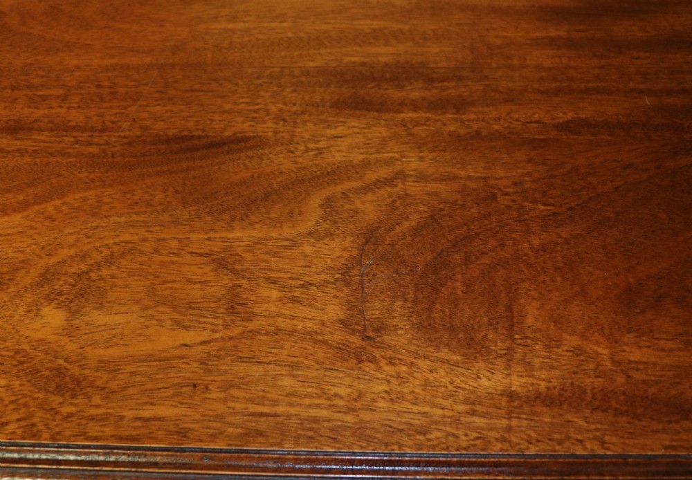 A solid mahogany bachelors chest featuring a pull-out slide, two upper drawers, three lower drawers, brass handles, and carved corner pilasters. View XIII