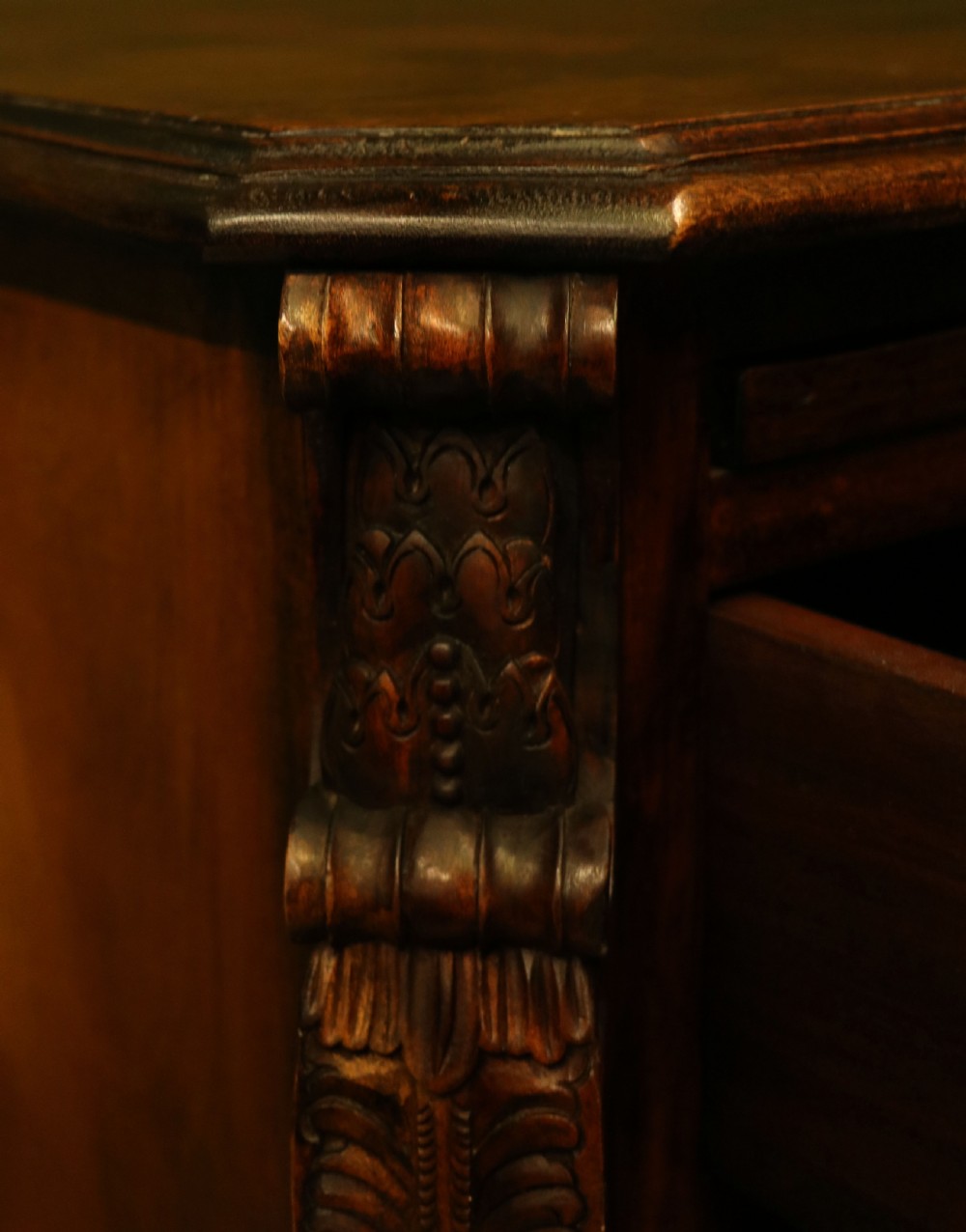 A solid mahogany bachelors chest featuring a pull-out slide, two upper drawers, three lower drawers, brass handles, and carved corner pilasters. View XVIII