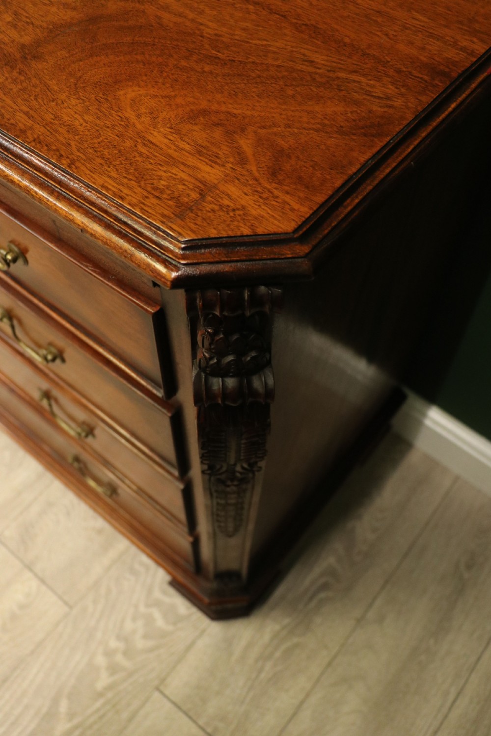 A solid mahogany bachelors chest featuring a pull-out slide, two upper drawers, three lower drawers, brass handles, and carved corner pilasters. View XXI