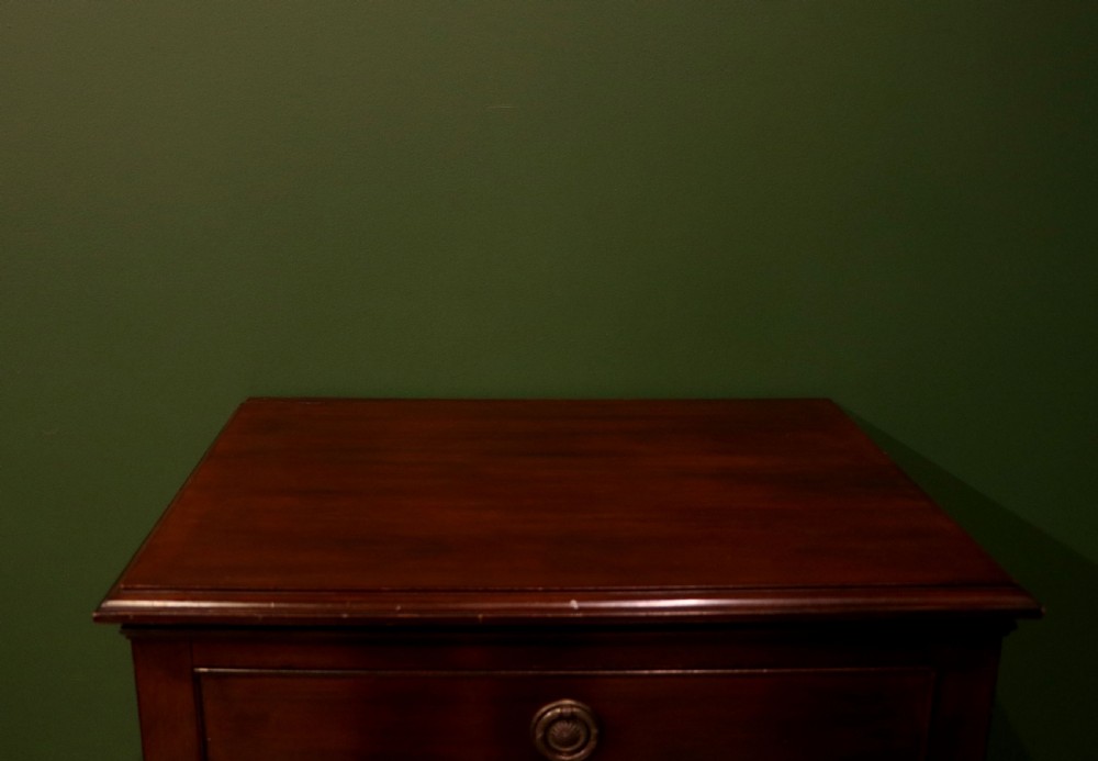 A tall, narrow dark mahogany music cabinet featuring seven fall-front drawers with central brass ring handles and an open shelf near the base. View XIV