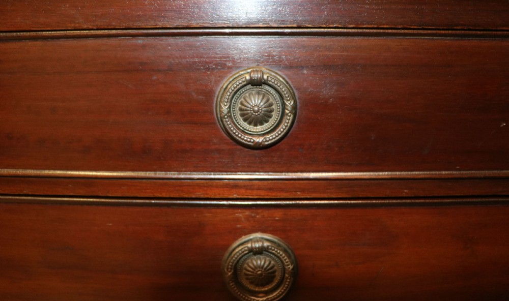 A tall, narrow dark mahogany music cabinet featuring seven fall-front drawers with central brass ring handles and an open shelf near the base. View XX