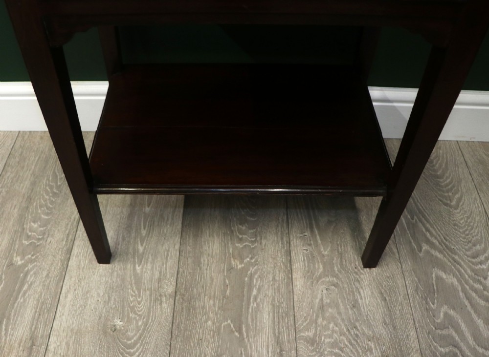 A tall, narrow dark mahogany music cabinet featuring seven fall-front drawers with central brass ring handles and an open shelf near the base. View XXII