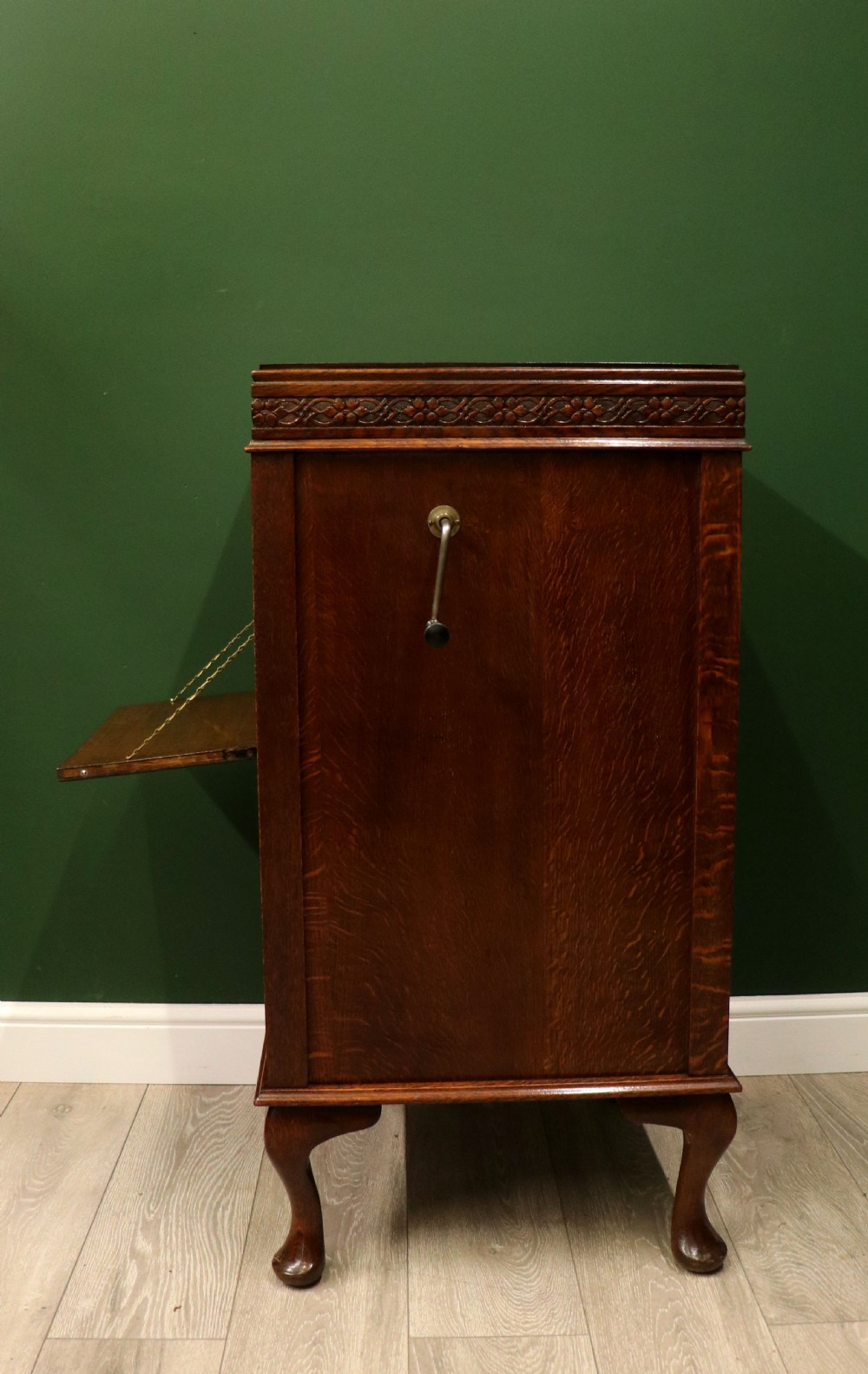 An upright dark oak parlour gramophone cabinet featuring cabriole legs, a hinged lid, carved rope detailing, and gothic arch fretwork grilles. View X