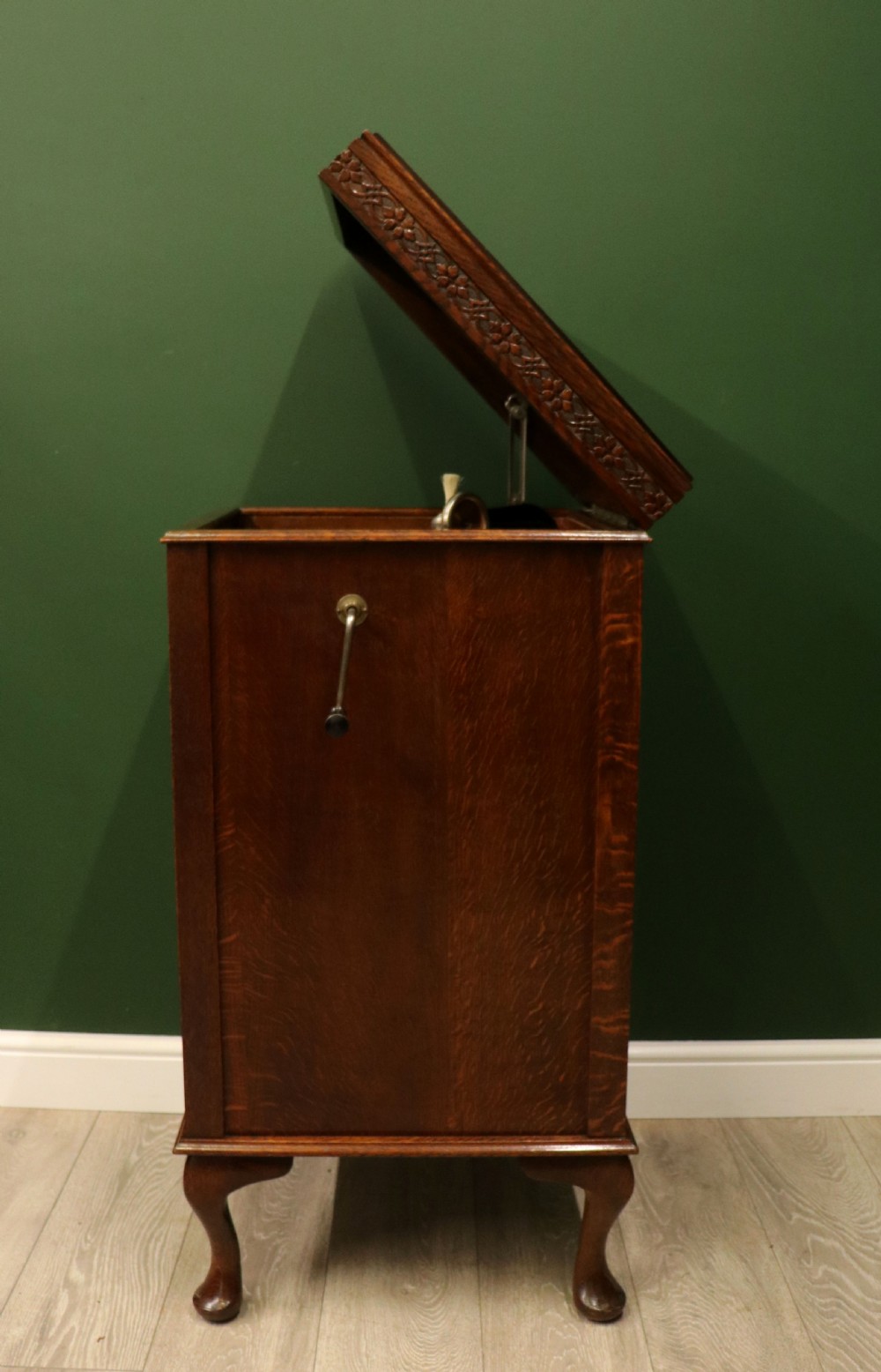 An upright dark oak parlour gramophone cabinet featuring cabriole legs, a hinged lid, carved rope detailing, and gothic arch fretwork grilles. View XI
