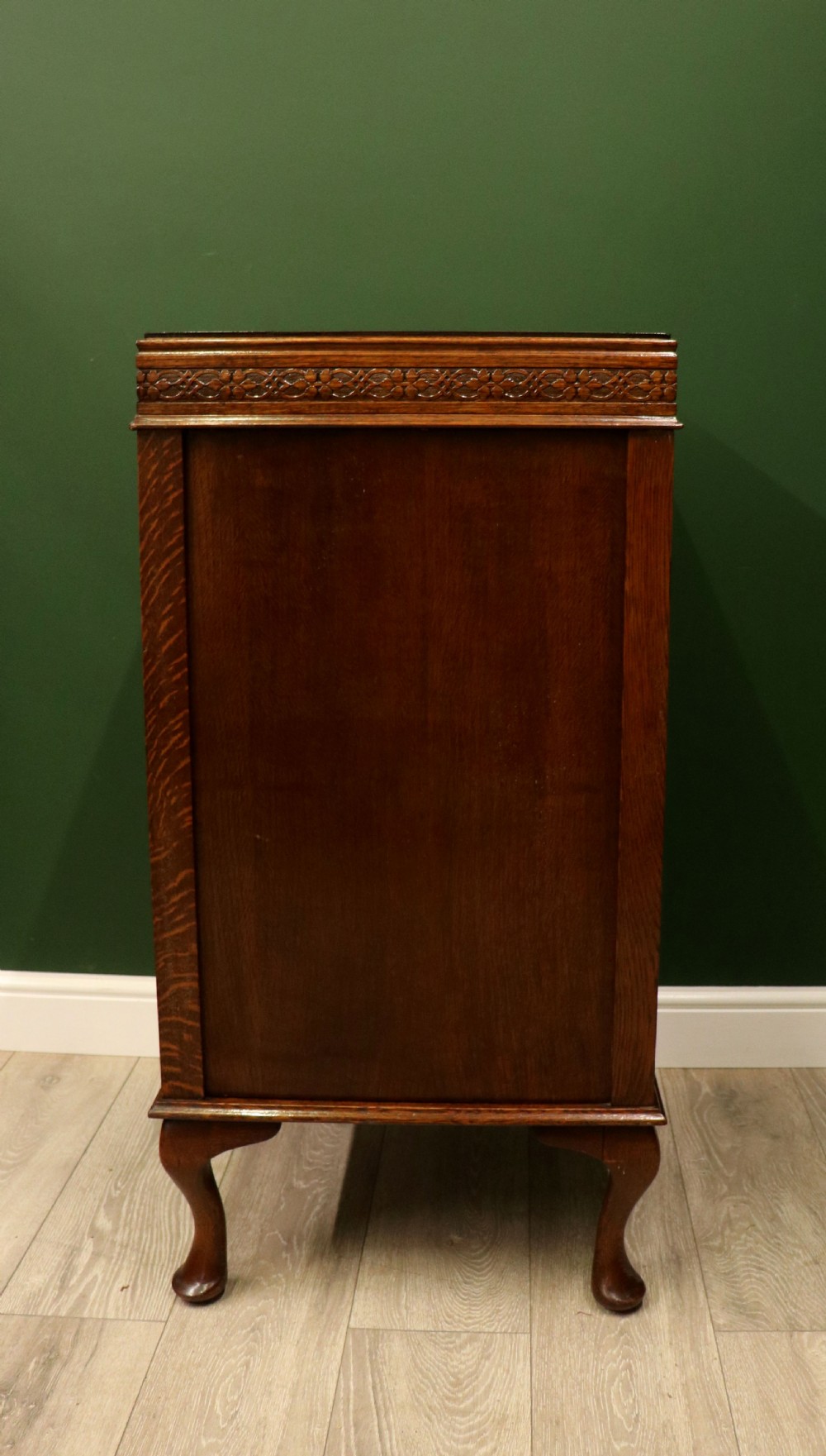 An upright dark oak parlour gramophone cabinet featuring cabriole legs, a hinged lid, carved rope detailing, and gothic arch fretwork grilles. View XII