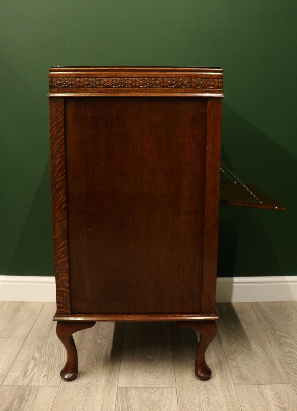 An upright dark oak parlour gramophone cabinet featuring cabriole legs, a hinged lid, carved rope detailing, and gothic arch fretwork grilles. View XIII
