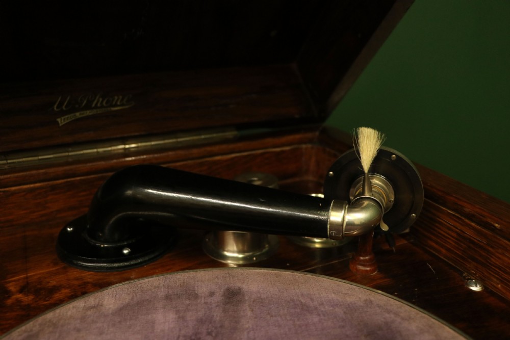 An upright dark oak parlour gramophone cabinet featuring cabriole legs, a hinged lid, carved rope detailing, and gothic arch fretwork grilles. View XX