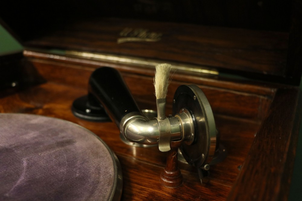 An upright dark oak parlour gramophone cabinet featuring cabriole legs, a hinged lid, carved rope detailing, and gothic arch fretwork grilles. View XXI