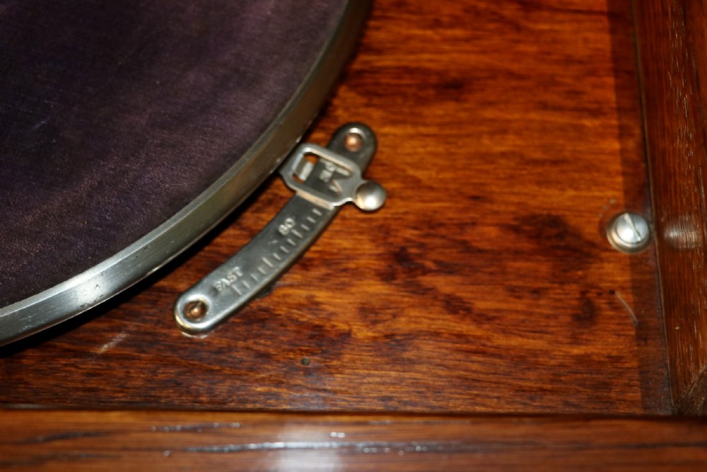 An upright dark oak parlour gramophone cabinet featuring cabriole legs, a hinged lid, carved rope detailing, and gothic arch fretwork grilles. View XXIII