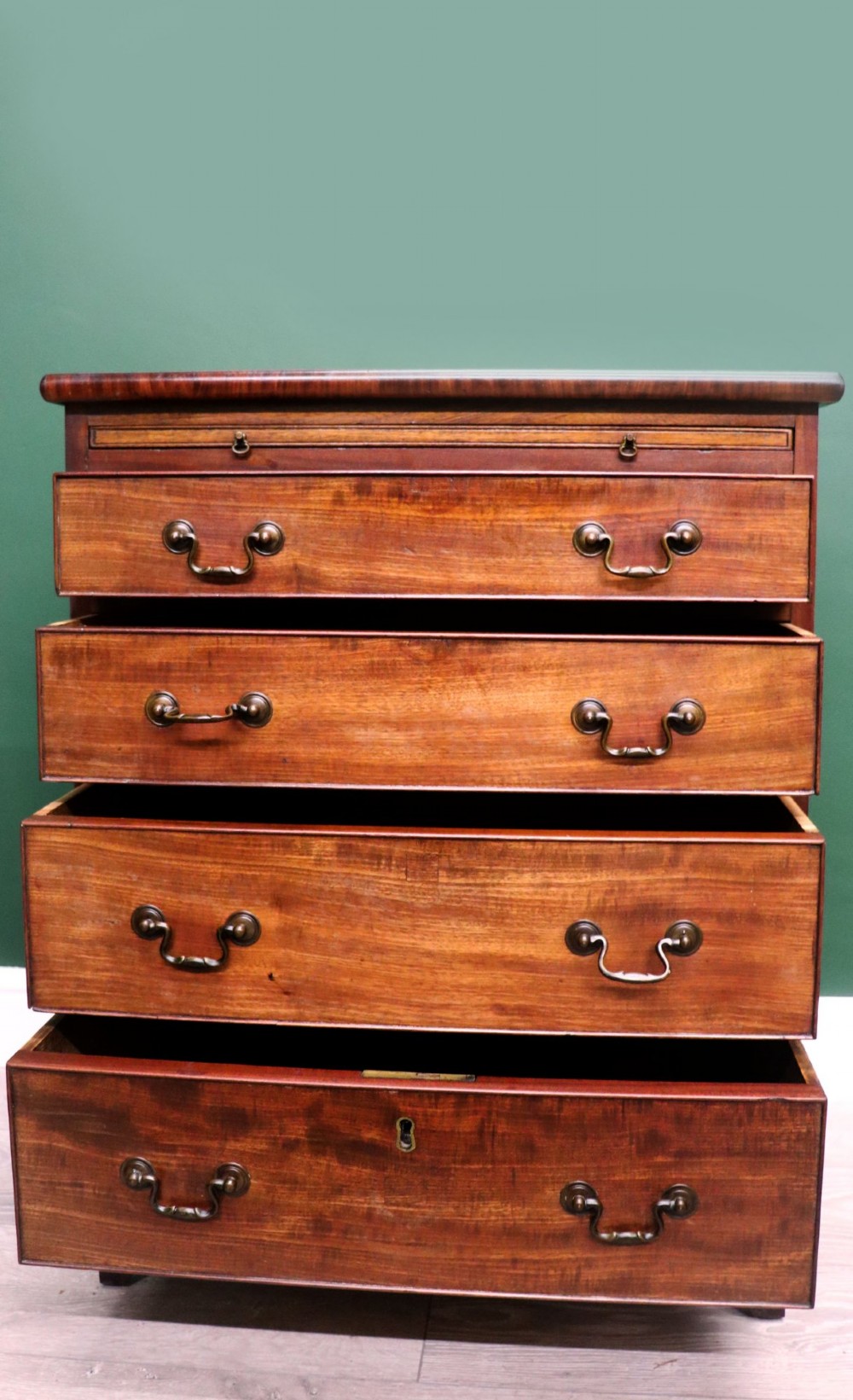 A lovely mahogany bachelors chest constructed in the George III style. View III