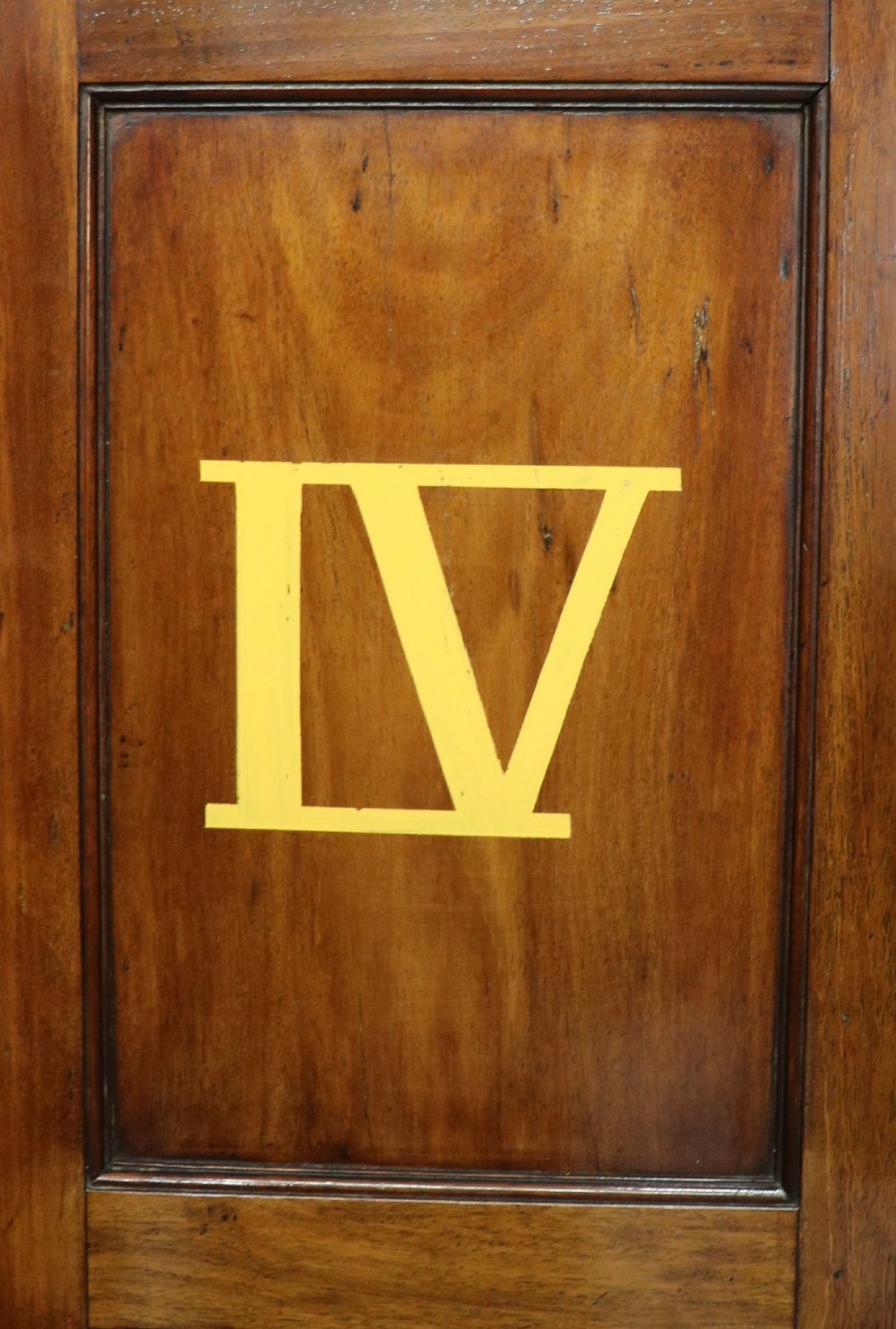 A George III mahogany wall-mounted corner cabinet with double panelled doors featuring painted yellow Roman numerals and a top frieze reading WHITEHALL 1212. View VII
