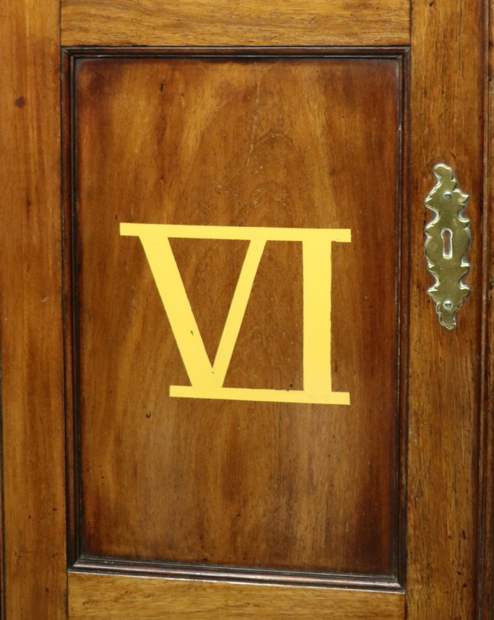 A George III mahogany wall-mounted corner cabinet with double panelled doors featuring painted yellow Roman numerals and a top frieze reading WHITEHALL 1212. View IX