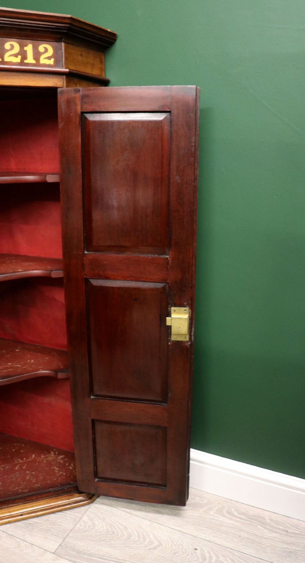 A George III mahogany wall-mounted corner cabinet with double panelled doors featuring painted yellow Roman numerals and a top frieze reading WHITEHALL 1212. View XIV