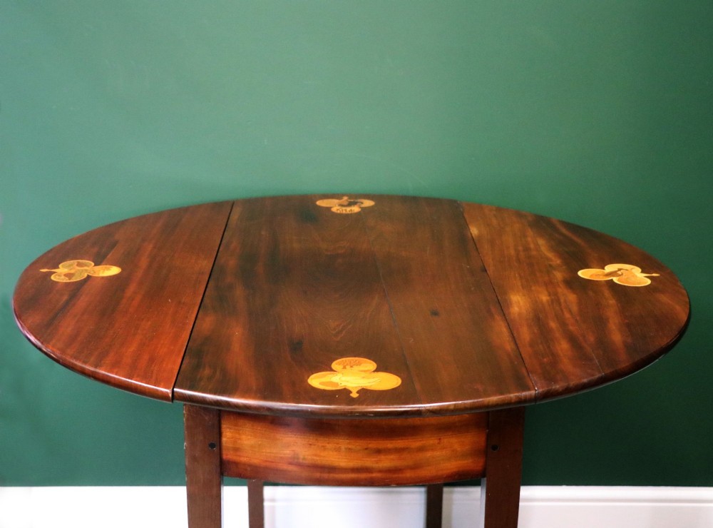 An Edwardian mahogany oval Pembroke table featuring drop leaves and inlaid clover motifs on tapered legs. View II