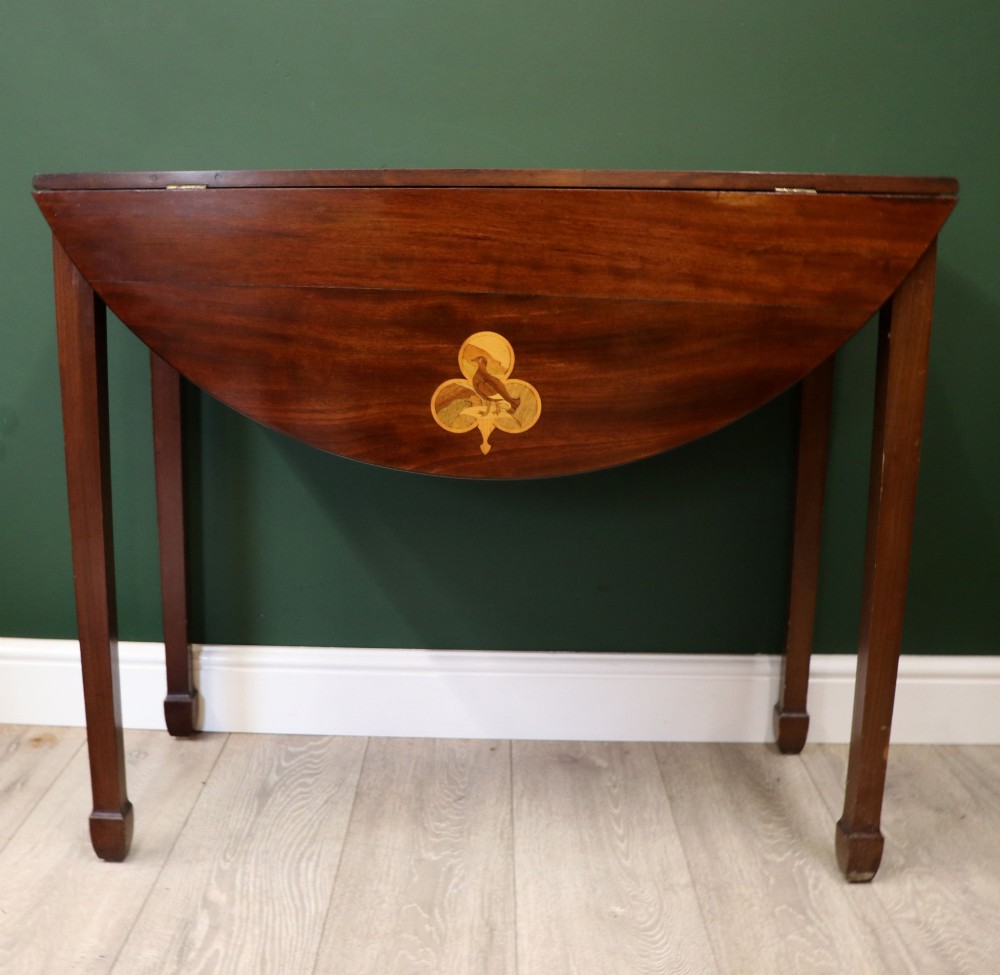 An Edwardian mahogany oval Pembroke table featuring drop leaves and inlaid clover motifs on tapered legs. View III
