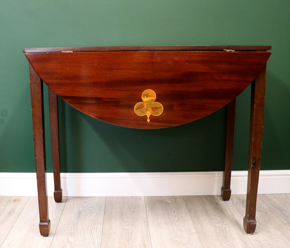 An Edwardian mahogany oval Pembroke table featuring drop leaves and inlaid clover motifs on tapered legs. View VII