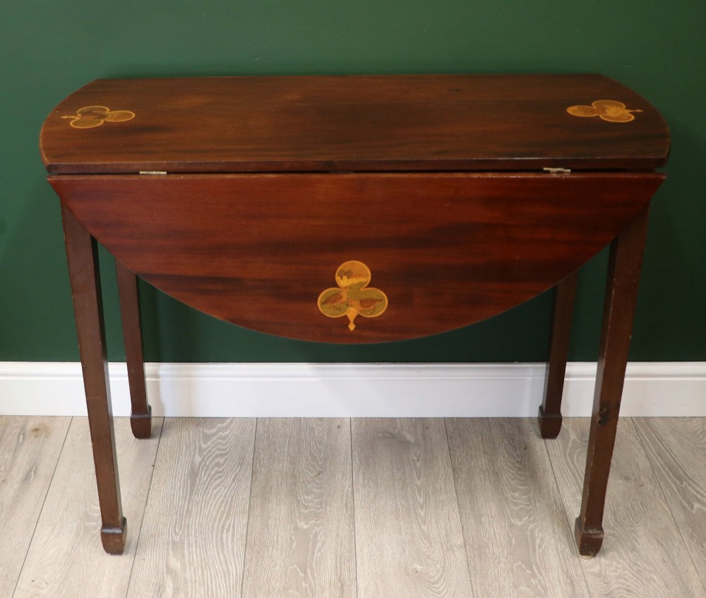 An Edwardian mahogany oval Pembroke table featuring drop leaves and inlaid clover motifs on tapered legs. View VIII