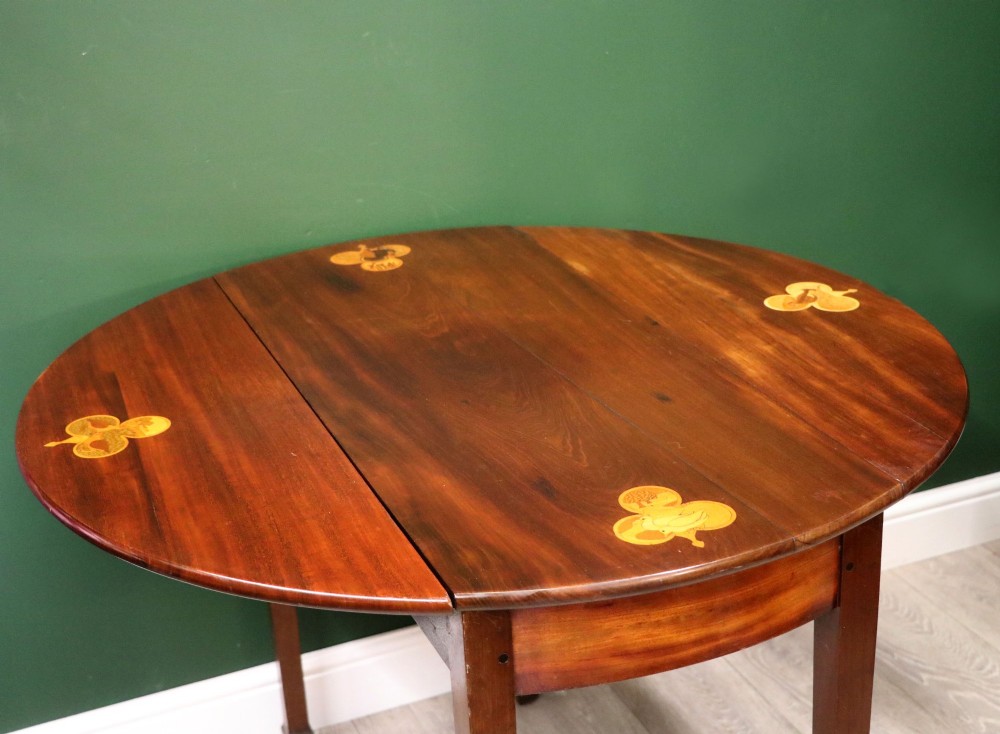 An Edwardian mahogany oval Pembroke table featuring drop leaves and inlaid clover motifs on tapered legs. View XII
