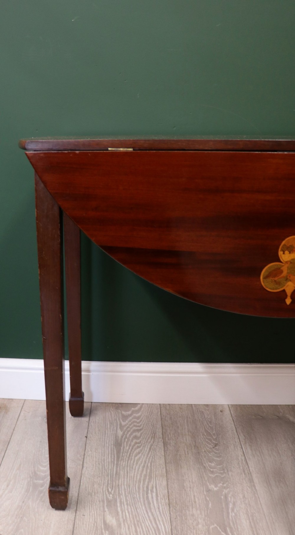 An Edwardian mahogany oval Pembroke table featuring drop leaves and inlaid clover motifs on tapered legs. View XIII