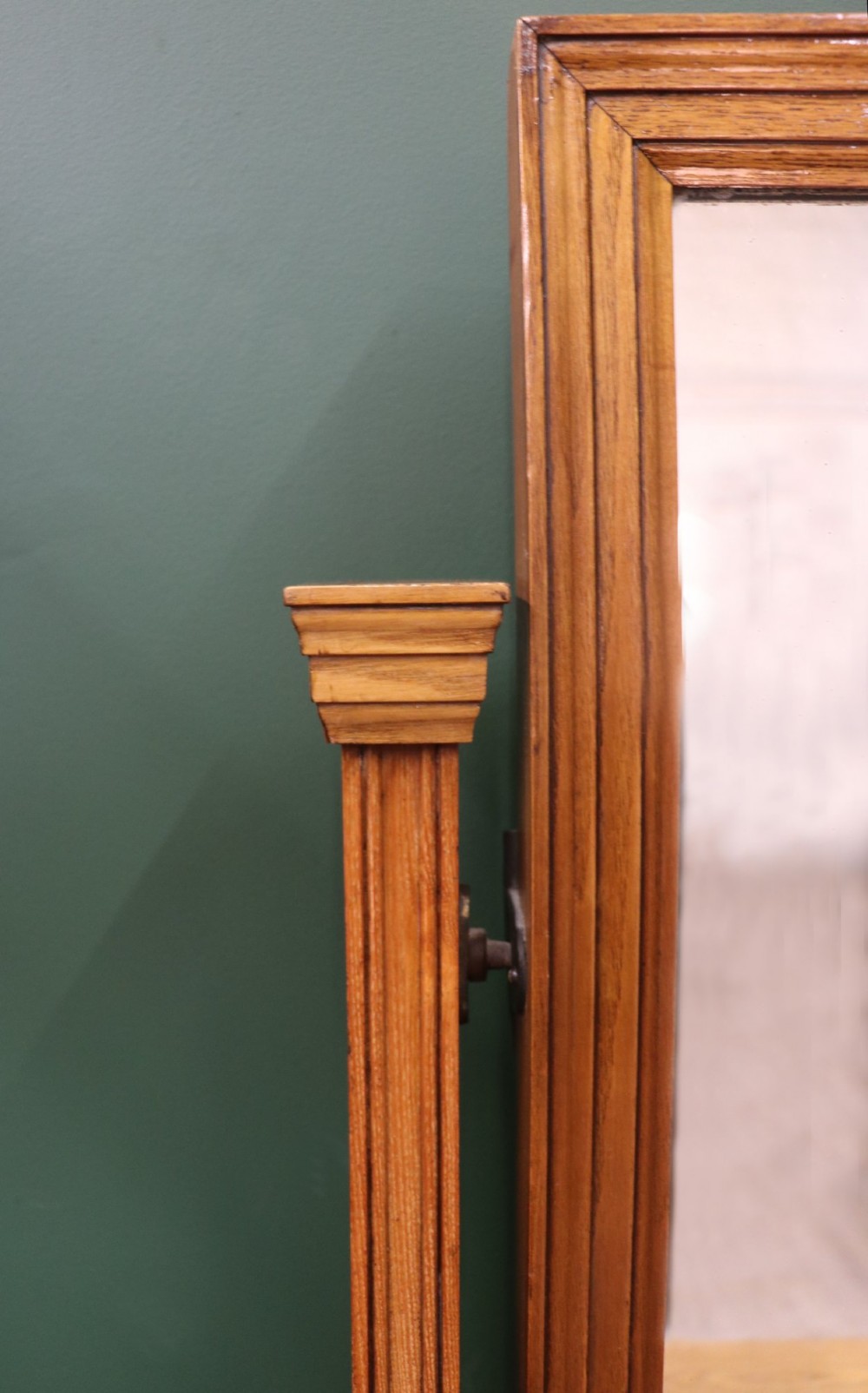 A late Victorian light walnut dressing table featuring an attached rectangular mirror, three small upper drawers, two panelled side cupboards, and turned legs with castors. View VII