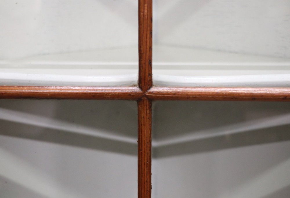 An early 20th-century floor-standing oak corner cabinet featuring an arched glazed upper door and a solid wood lower cupboard door. View IX