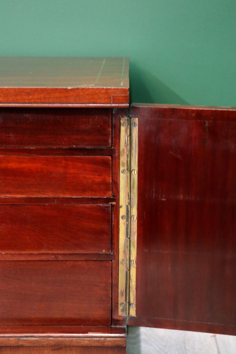A mahogany campaign style collectors cabinet featuring geometric brass line inlays, twin front doors, a brass central keyhole, and shaped feet. View XIII