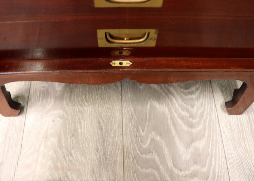 A mahogany campaign style collectors cabinet featuring geometric brass line inlays, twin front doors, a brass central keyhole, and shaped feet. View XIV