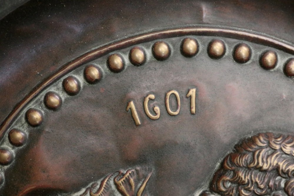 Pair of circular relief-embossed copper wall chargers depicting profile portraits of King Henry IV and Queen Marie de Medicis surrounded by floral and mask borders. View VIII