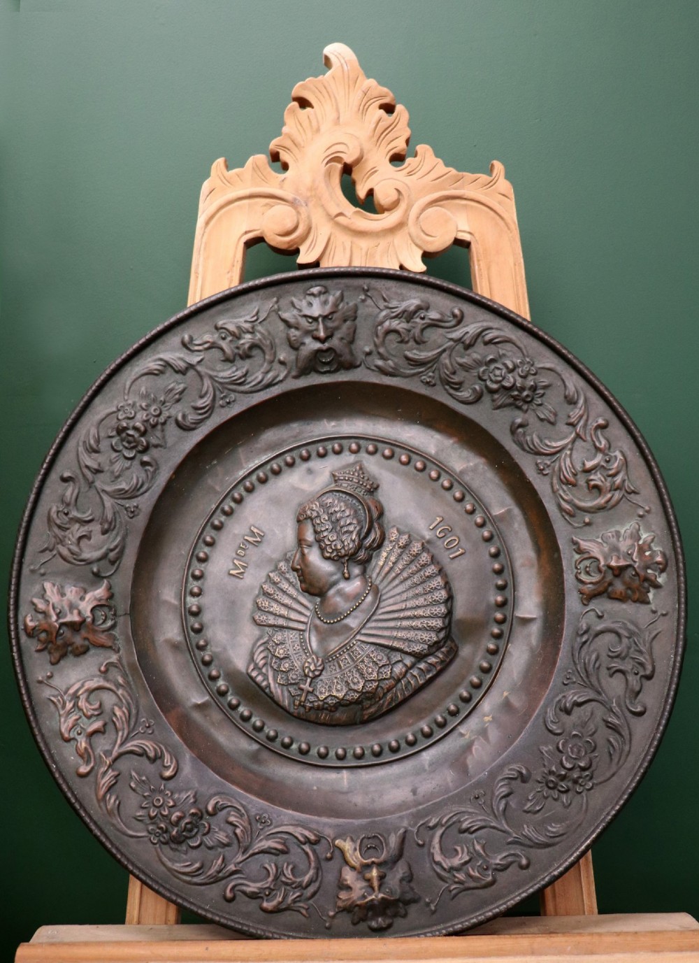 Pair of circular relief-embossed copper wall chargers depicting profile portraits of King Henry IV and Queen Marie de Medicis surrounded by floral and mask borders. View IX