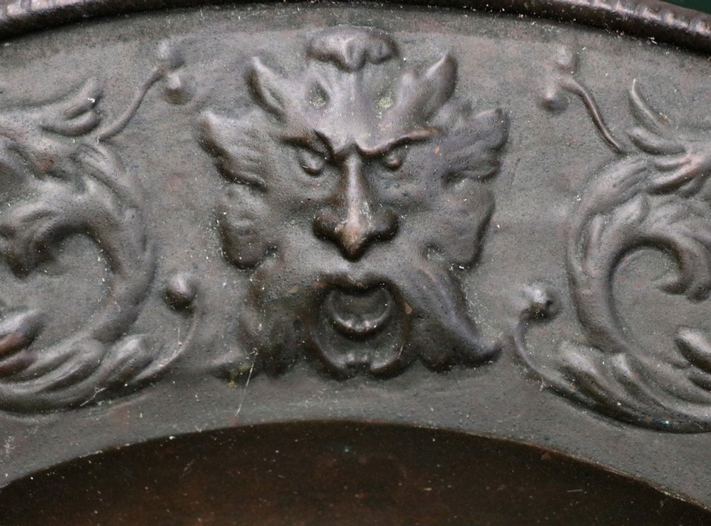 Pair of circular relief-embossed copper wall chargers depicting profile portraits of King Henry IV and Queen Marie de Medicis surrounded by floral and mask borders. View XII