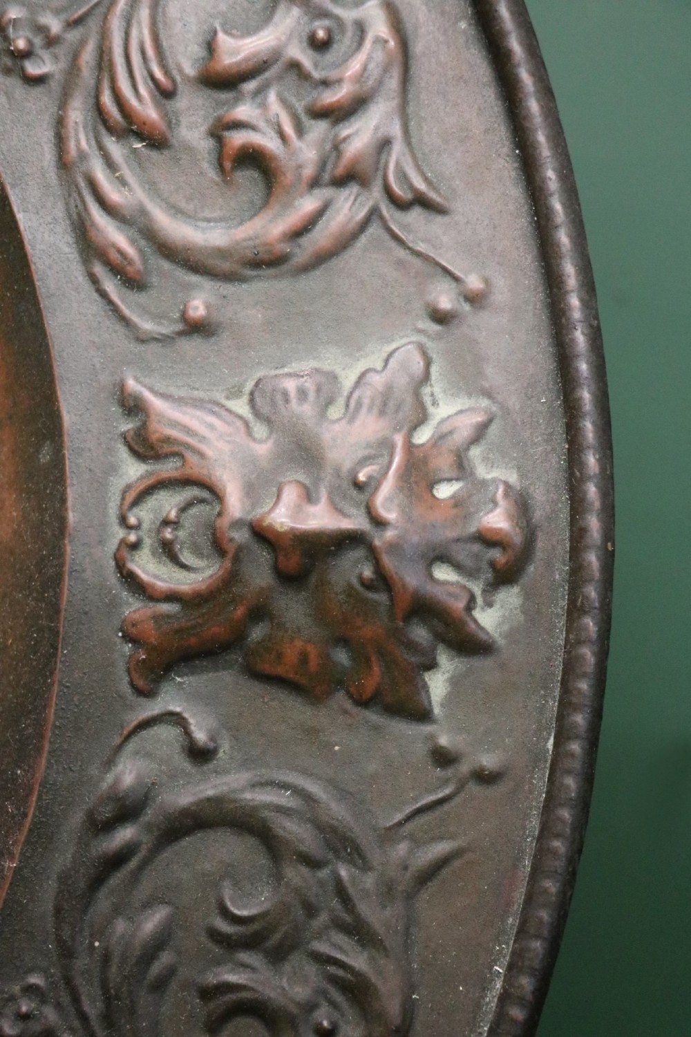 Pair of circular relief-embossed copper wall chargers depicting profile portraits of King Henry IV and Queen Marie de Medicis surrounded by floral and mask borders. View XIII