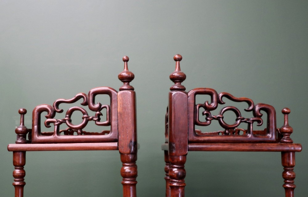 A matching pair of Victorian dark wood five-tier corner whatnots featuring turned spindle supports, carved pierced galleries, and decorative finials. View VII