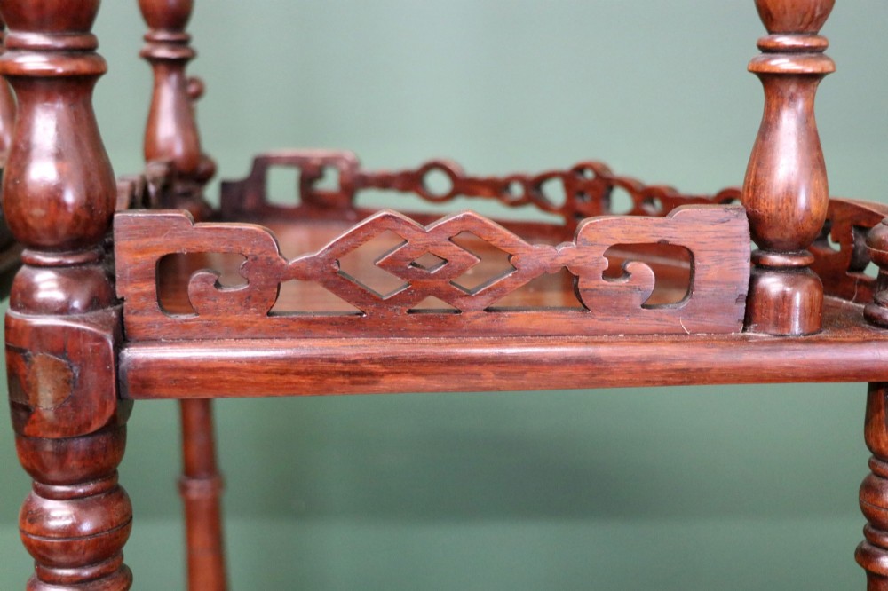 A matching pair of Victorian dark wood five-tier corner whatnots featuring turned spindle supports, carved pierced galleries, and decorative finials. View XI