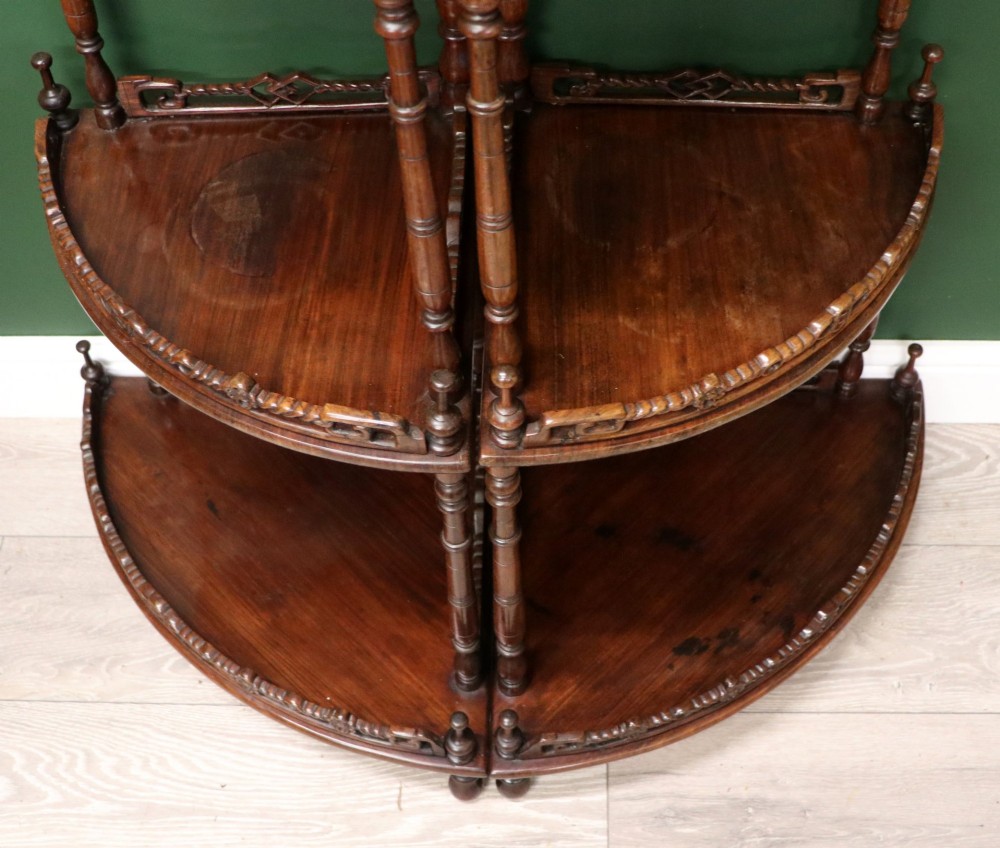A matching pair of Victorian dark wood five-tier corner whatnots featuring turned spindle supports, carved pierced galleries, and decorative finials. View XIII