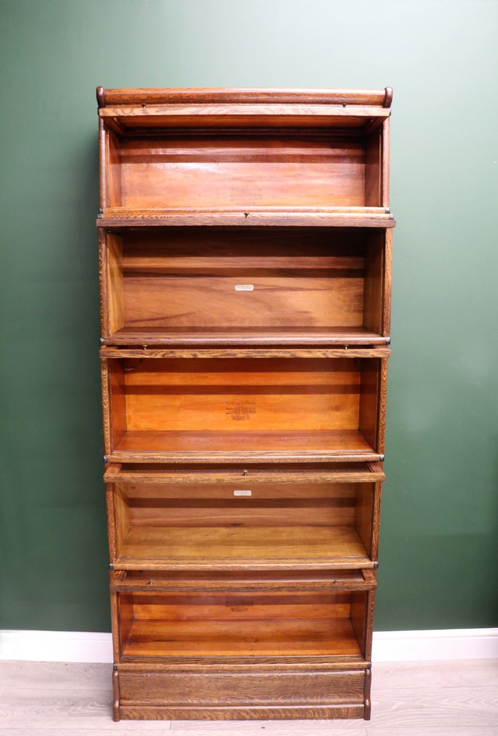 A five-tier Edwardian oak Globe Wernicke stacking bookcase with glass lift-up cabinet doors. View II