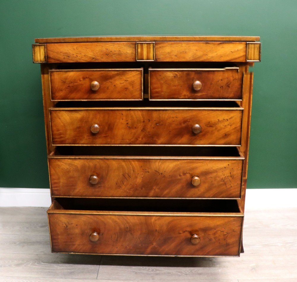 A small Victorian mahogany chest of drawers featuring decorative inlay along the frame, turned wooden knobs, and a shaped apron on curved feet. View III