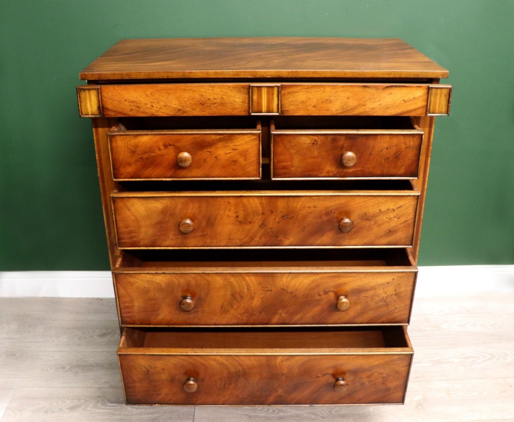A small Victorian mahogany chest of drawers featuring decorative inlay along the frame, turned wooden knobs, and a shaped apron on curved feet. View IV